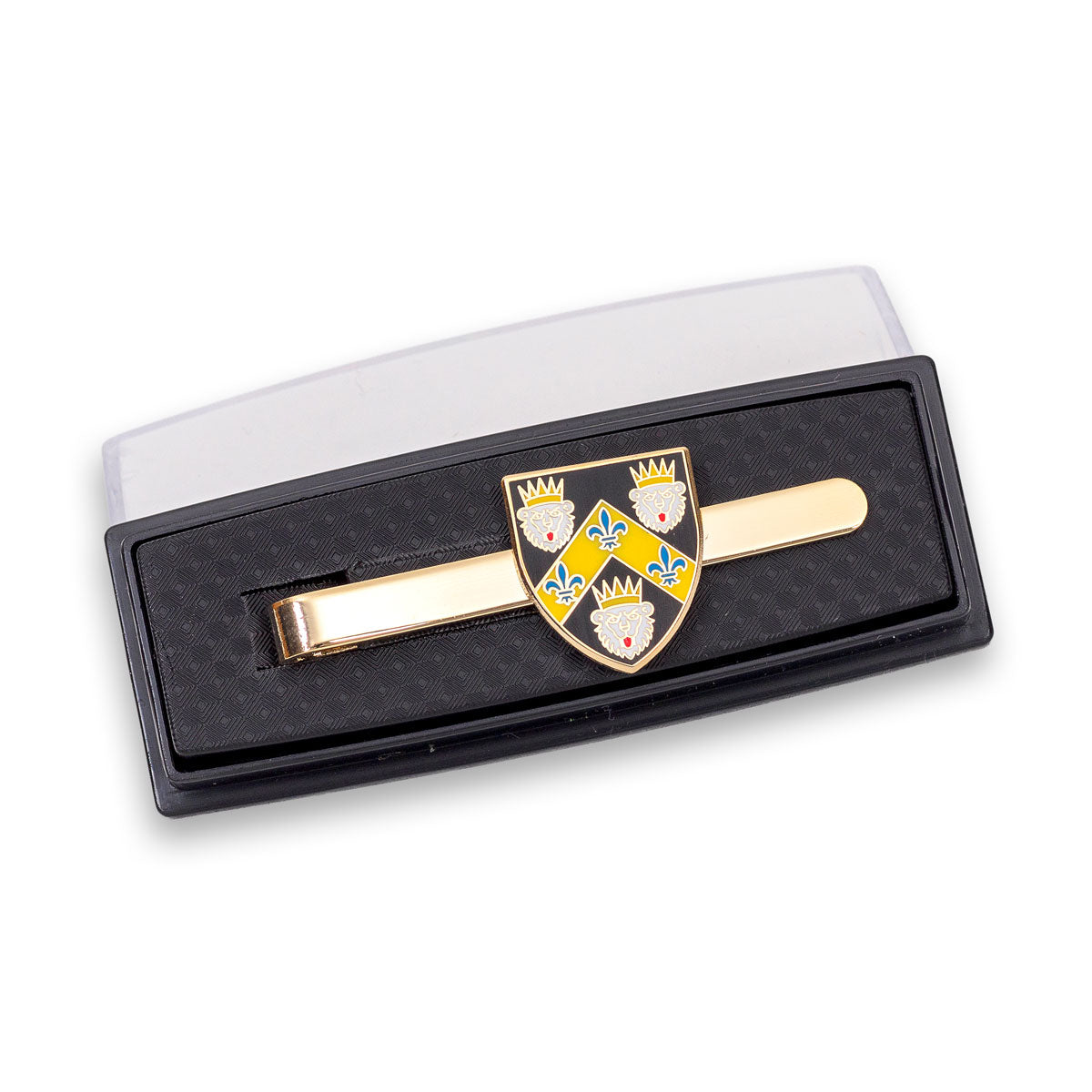 Gold tie clip with a shield design in a black box on a white background